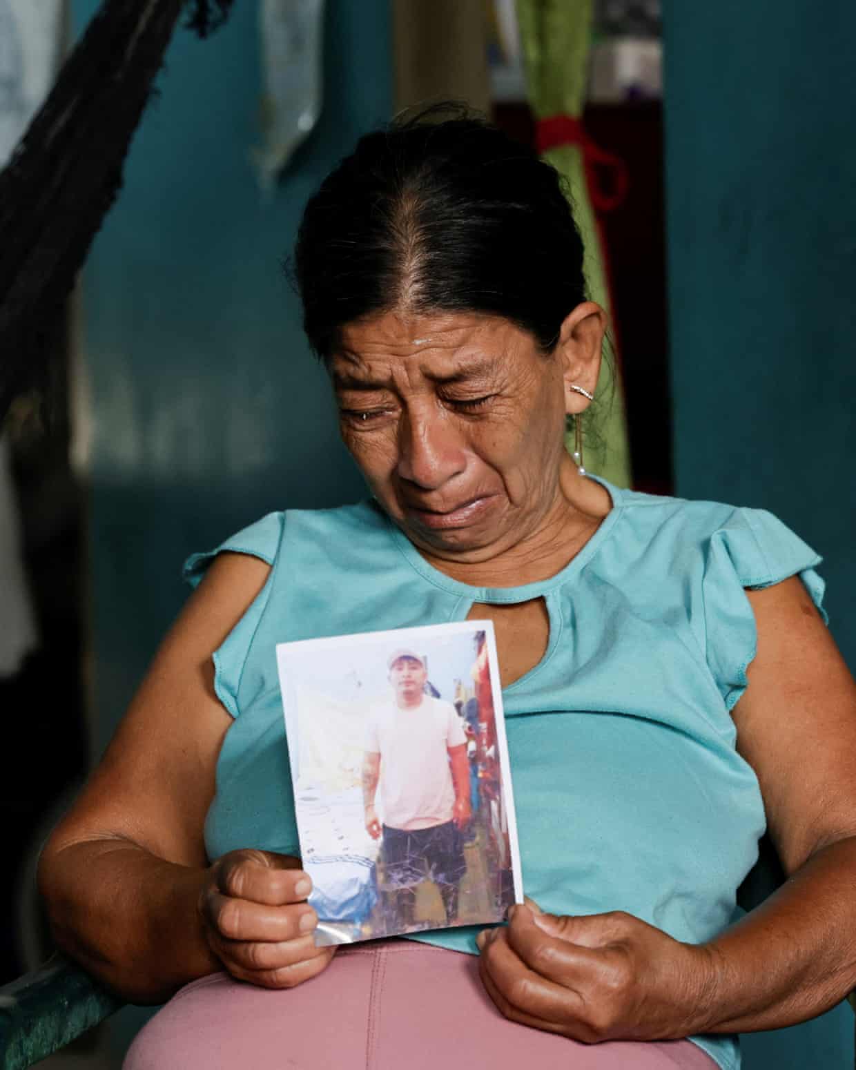 Woman crying holds photo in her hand