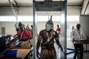 A dancer passes through a security checkpoint at the Jomo Kenyatta international airport prior to the arrival of the FIFA World Cup trophy during its world tour.