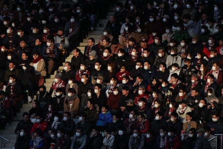 Fans wear face masks at a football match in Kobe, Japan.