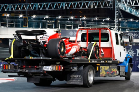 Carlos Sainz’s Ferrari is removed from the circuit on a truck.