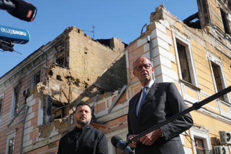 Volodymyr Zelenskyy,Friedrich MerzUkraine's President Volodymyr Zelenskyy, centre, and German Chancellor Friedrich Merz speak to media with Academy of science building damaged after a Russian drone strike, on the background, Kyiv, Ukraine, Sunday, Oct. 4, 2026. (AP Photo/Evgeniy Maloletka)
