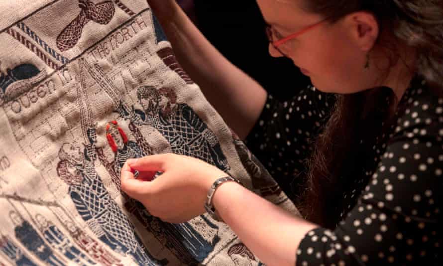 An embroiderer at work on the final section of the Game of Thrones tapestry