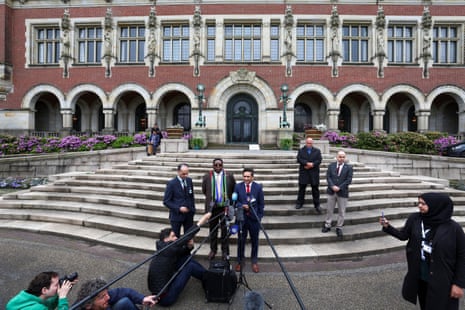 Palestinian official Ammar Hijazi, director general of the ministry of international relations of South Africa, Zane Dangor and South African ambassador to the Netherlands Vusimuzi Madonsela speak to the media outside the International Court of Justice (ICJ) on Friday.
