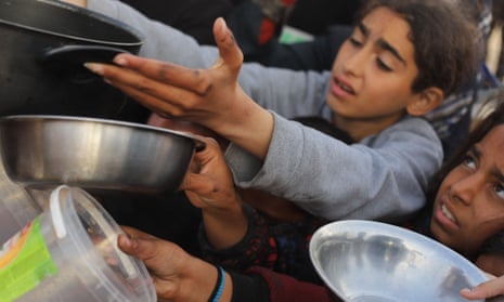 Children in Gaza try to get food relief.