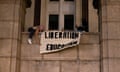 Demonstrators from the pro-Palestine encampment on Columbia University campus unfurl a banner as they barricade themselves inside Hamilton Hall