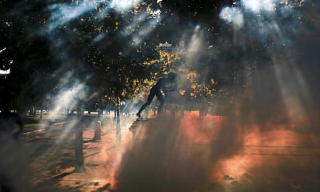 Tear gas surrounds a statue on Syntagma square during clashes between police and protesters in Athens.