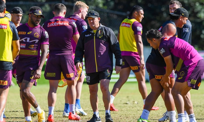 Kevin Walters is surrounded by players during a training session