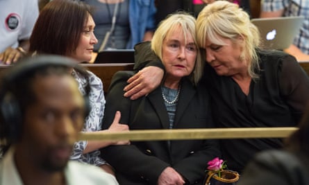June Steenkamp is embraced by a relative as appeals court judge Leach finds Pistorius guilty of murder.