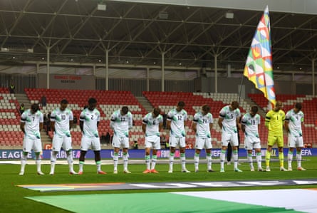 Republic of Ireland players bow their heads and wear black armbands during the Israeli anthem.