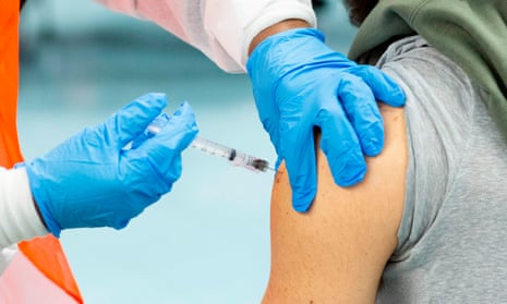 A man receives a dose of the Moderna coronavirus vaccine.
