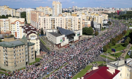 Opposition supporters parade through the streets during a rally to protest against the Belarus presidential election results in Minsk on 13 September 2020.