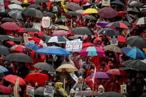 Demonstrators hold signs while marching during a teachers strike in Los Angeles, California on 14 January 2019. Tens of thousands of teachers in Los Angeles walked off the job after months of negotiations between their union and the second largest US school district failed to resolve long-simmering disputes over pay raises, class sizes, inadequate support staffing and public funding for charter schools.