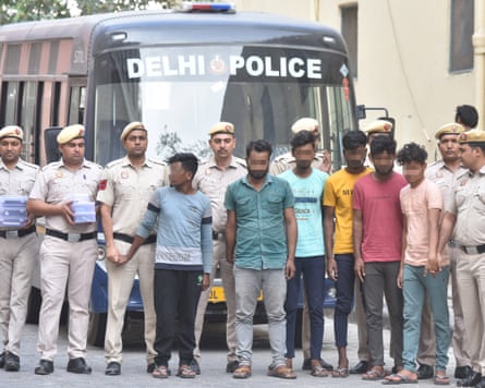 Cybercrime police in Delhi after arresting members of a scam-call syndicate operating from Jamtara in April 2023. (Faces pixellated by Guardian imaging.)