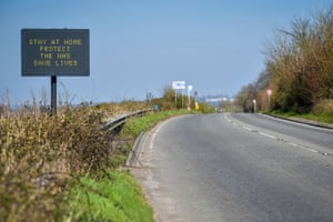 A matrix road sign on the A367 into Bath, south west England, advises motorists to stay at home to protect the NHS and save lives