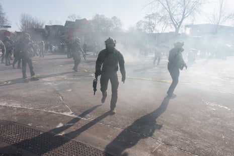 A federal agent walks through a cloud of teargas in Minneapolis, Minnesota, on 24 January 2026.