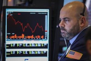 A trader works at his desk at the closing bell on the floor of the New York Stock Exchange last night
