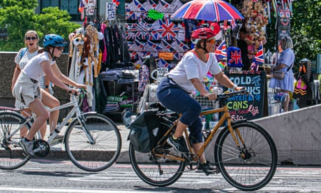 Cyclists pass a souvenir kios on Westminster Bridge in London, cycling has risen 47% on weekends in the capital.