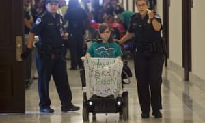 Disability advocates hold a protest outside the office of Senate majority leader Mitch McConnell on 22 June. Senate Republicans have released their draft healthcare bill.