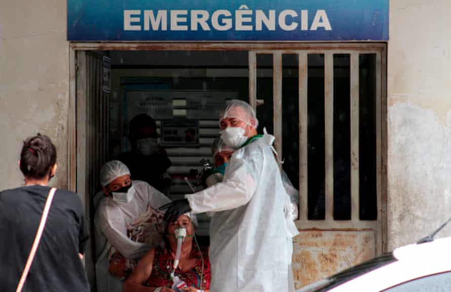 Health workers bring a patient in the Emergency room of the public hospital in Manacapuru, Amazonas state, on 20 January.