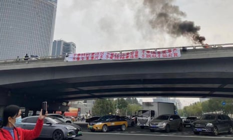 Protest banners reportedly seen on Sitong Bridge overpass in Beijing on Thursday, in an image shared on social media