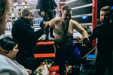 Khrebet being helped down from the ring