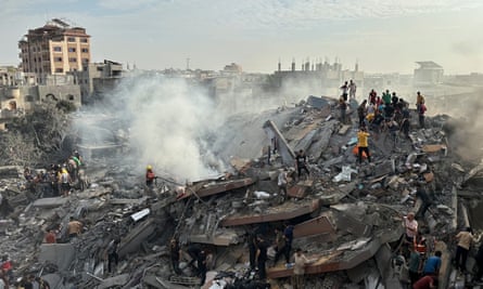 People look for survivors after an Israeli airstrike at Nuseirat refugee camp in Gaza