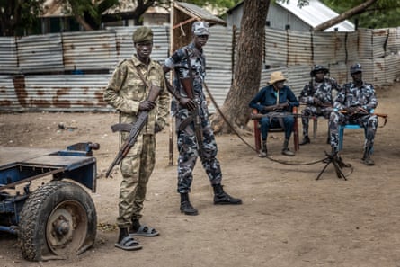 Members of the SPLA-IO gather at a security post outside local government offices in Akobo, Jonglei state