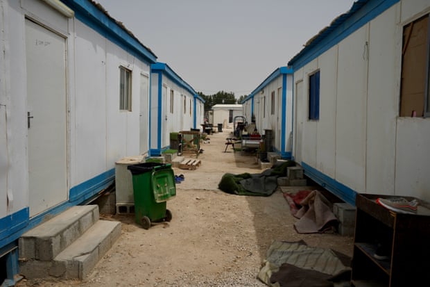 Two rows of shabby portable cabins with few windows
