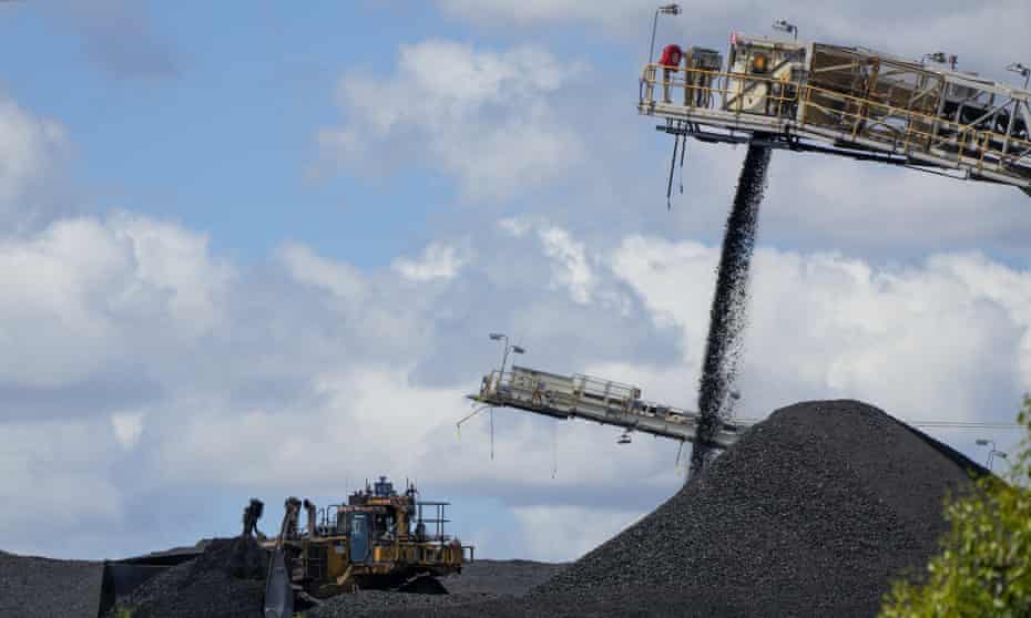 Heavy machinery moves coal as it is poured onto a stack near Muswellbrook in the Hunter Valley, Australia, Tuesday, Nov. 2, 2021.