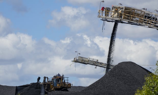 Heavy machinery moves coal