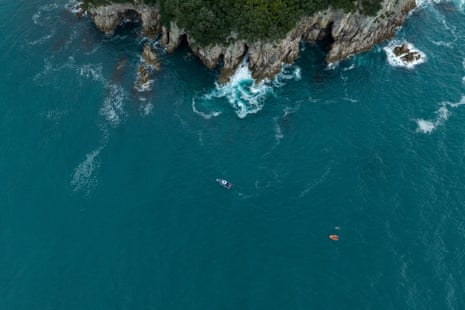 Aerial view of the sea and a swimmer off the coast