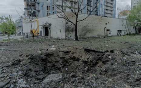 A shell crater in front of a residential building damaged by Russian shelling on Wednesday in Kharkiv, Ukraine.