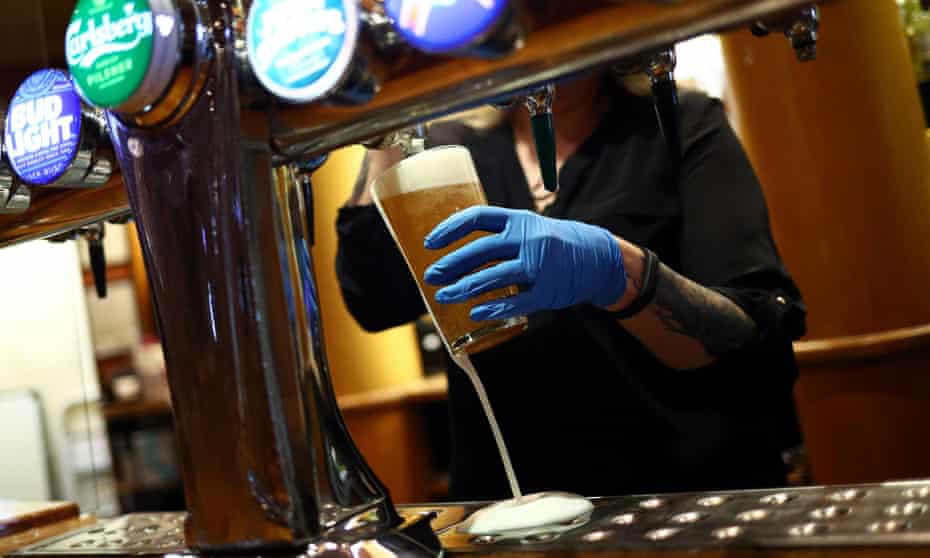 A worker serves a beer at a Wetherspoon's pub