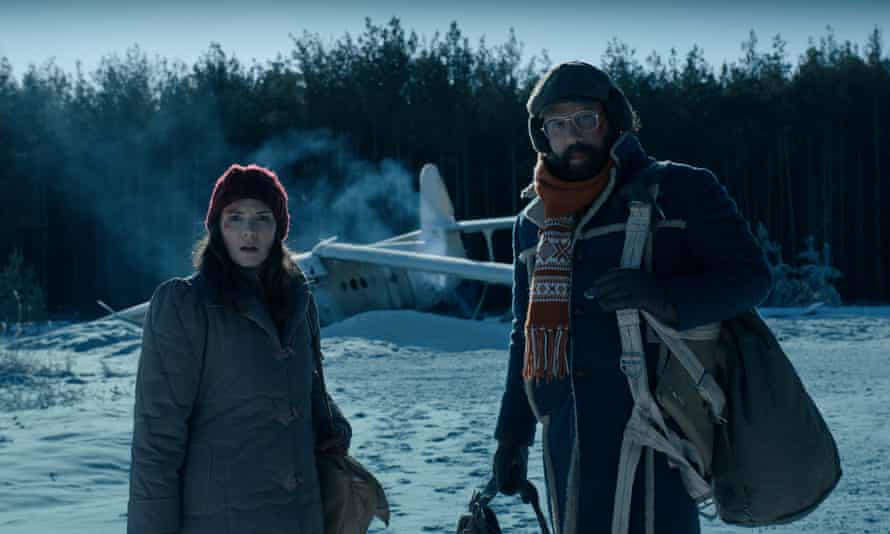 Winona Ryder and Brett Gelman in the snow, with a crashed plane, in season 4 of Stranger Things.