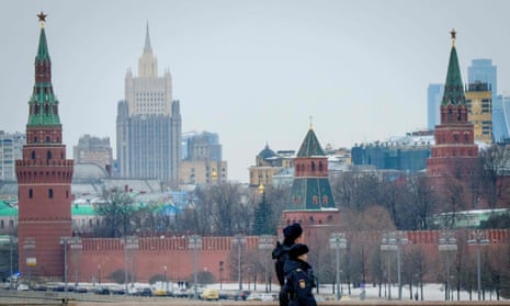 A pair of police officials patrol on a bridge outside The Kremlin in Moscow