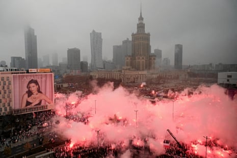 Participants light flares during the “Independence March” in Warsaw, Poland.