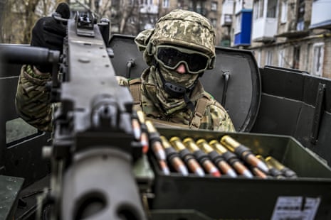 A Ukrainian soldier aims a machine gun in Chasiv Yar.