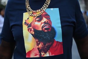 A fan at the memorial service wears a shirt with an image of Nipsey Hussle.