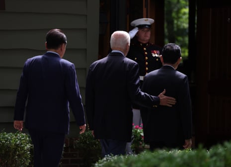 South Korean President Yoon Suk Yeol, US President Joe Biden and Japanese Prime Minister Fumio Kishida walk together at the Camp David presidential retreat in Maryland.