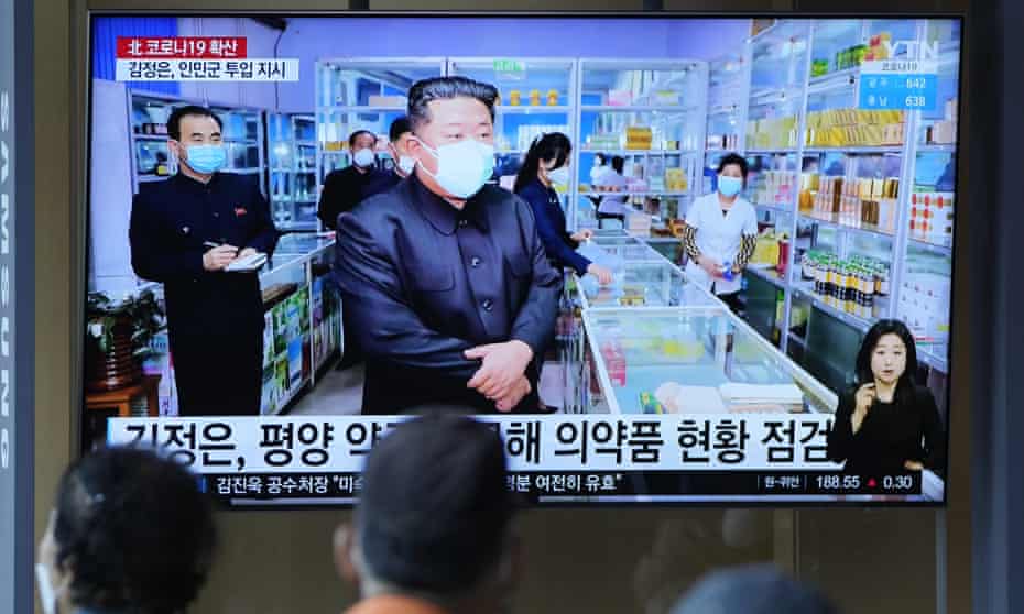 People watch a TV screen showing a news program reporting with an image of North Korean leader Kim Jong Un, at a train station in Seoul, South Korea,  May 16, 2022