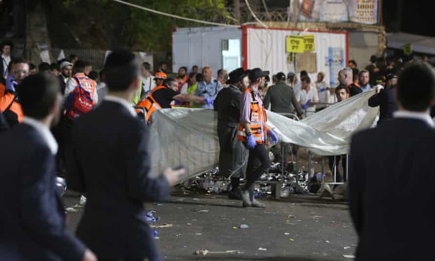 Israeli security officials and rescuers inspect the dead bodies of dozens of Ultra-Orthodox Jews who died in a crush during Lag Ba’Omer in Mount Meron