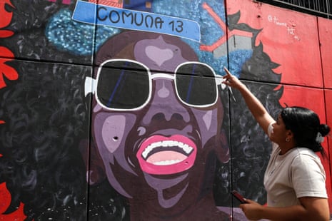 Ana Moreno, 32, standing next to her wall mural