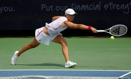 Iga Swiatek reaches for a backhand