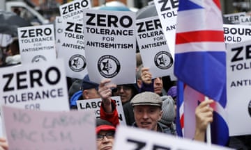 People hold up placards saying 'zero tolerance for antisemitism'