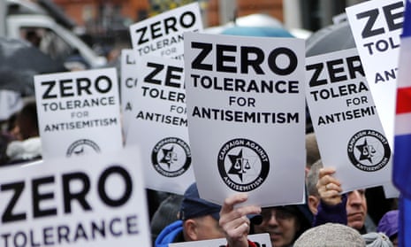 People hold up placards at an antisemitism protest in London this year.