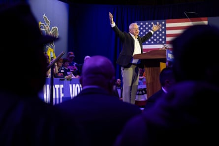 a man speaks with his arms raised at a lectern