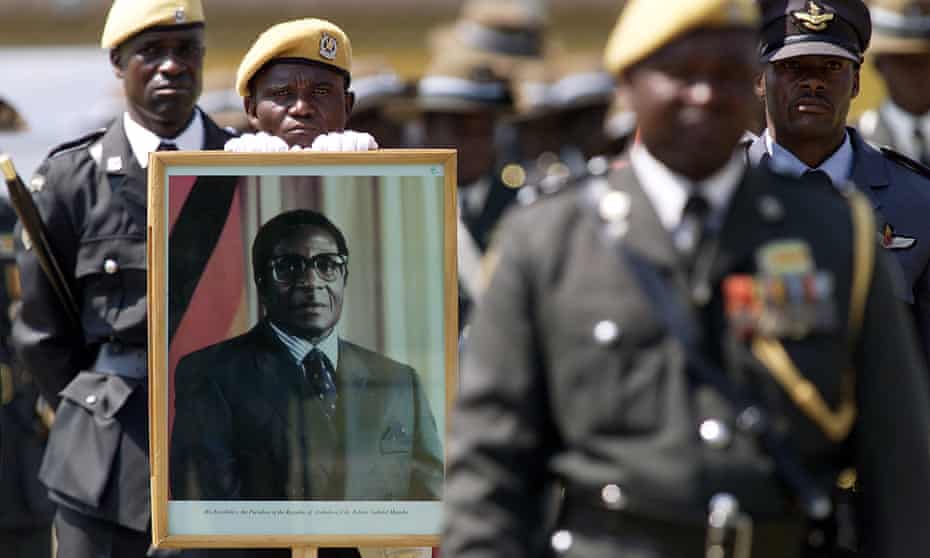 Portraits of Robert Mugabe have been ubiquitous, as in this armed forces day parade in 2003.