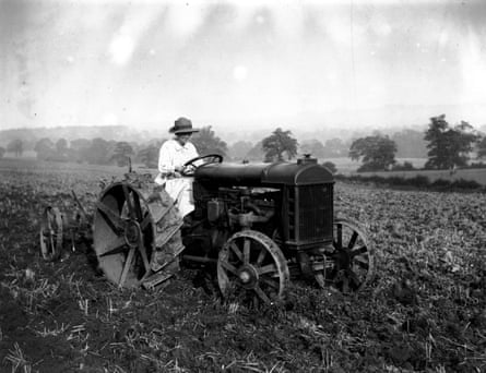 A woman ploughing a field on a farm in Macclesfield circa 1921