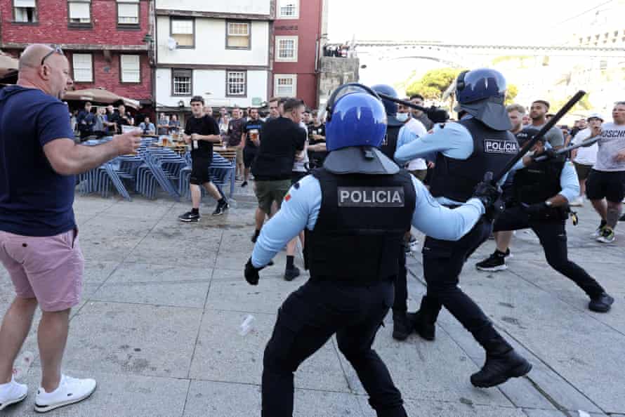 Police move in to stop a scuffle that started among supporters drinking by the Douro river on Friday..