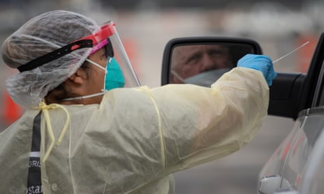 A healthcare worker prepares to use a swab to test a man for coronavirus in Houston, Texas, on 20 November. 